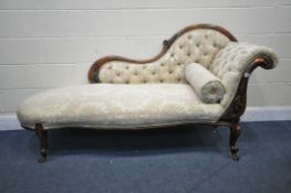 A VICTORIAN WALNUT CHAISE LOUNGE, with scrolled arm and shaped back, with foliate decoration, on