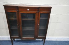 A SLIM MAHOGANY THREE DOOR GLAZED BREAKFRONT BOOKCASE, on square tapered legs, stamped old times