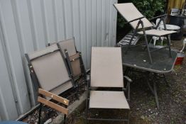 A FIVE PIECE PATIO SET, comprising a square glass top table, 106cm squared x 69cm height, and a
