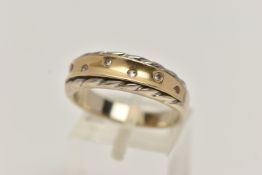 A BICOLOUR AND DIAMOND RING, seven round brilliant cut diamonds, flush set in yellow metal, with a