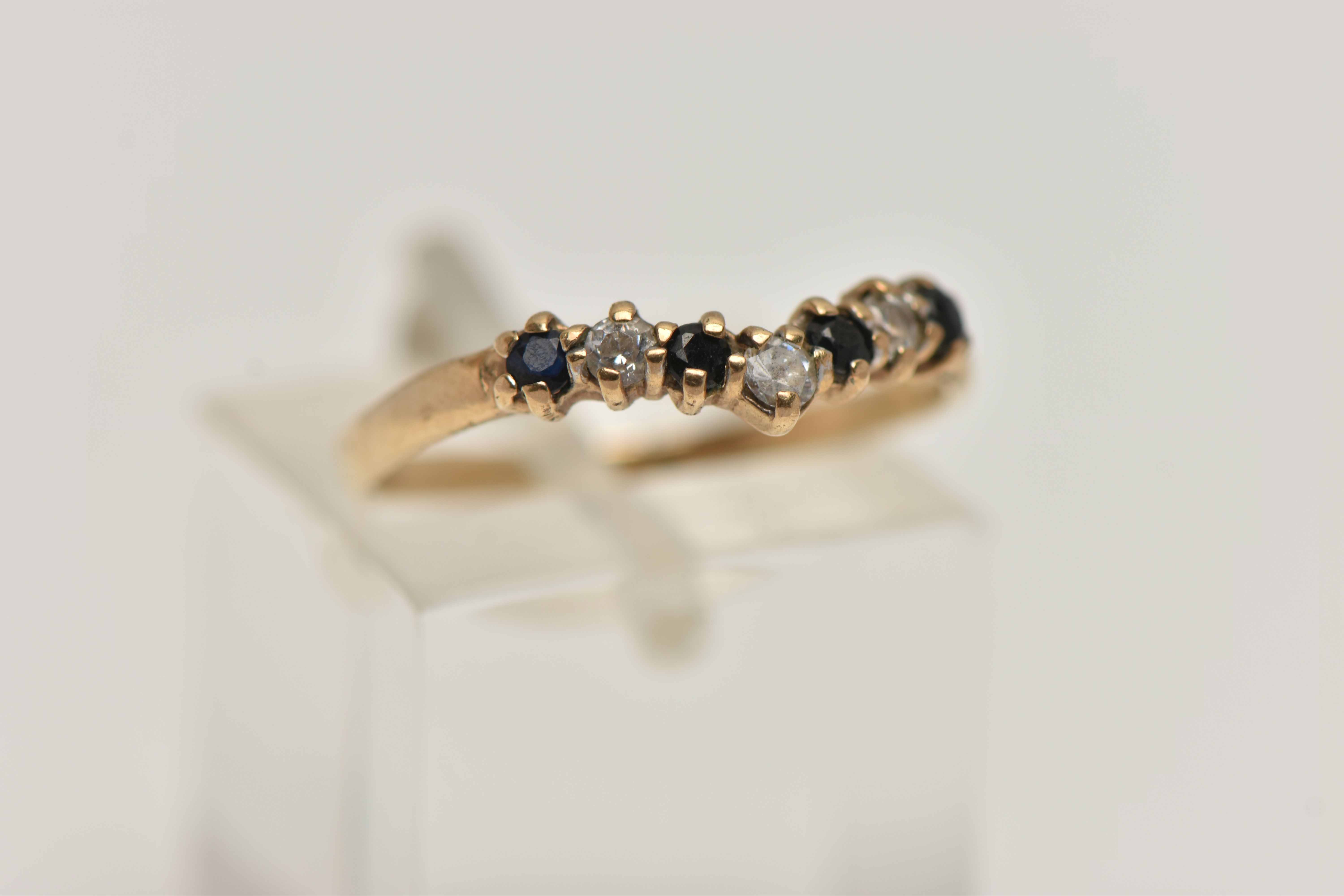 A 9CT GOLD SAPPHIRE AND CUBIC ZIRCONIA WISH BONE RING, alternating blue sapphires and colourless - Image 4 of 4