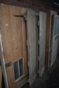 FIVE VARIOUS WOODEN EXTERNAL DOORS,of various shapes, sizes and ages, largest width 93cm x height
