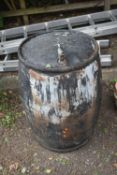 A BLACK PAINTED GALVANISED OIL BARREL, with a later added tap, diameter 66cm x height 92cm (