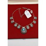 A BOXED WHITE METAL TURQUOISE NECKLACE, designed with a row of nine pierced pendants each set with
