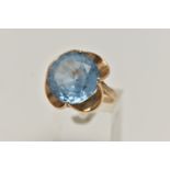 A 9CT GOLD GEM SET DRESS RING, set with a circular cut light blue stone assessed as synthetic