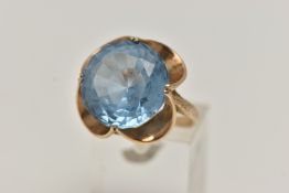 A 9CT GOLD GEM SET DRESS RING, set with a circular cut light blue stone assessed as synthetic