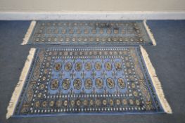 A WOOLLEN TEKKE RUG, with a blue field, 145cm x 99 cm, and a similar carpet runner 183cm x 63cm,