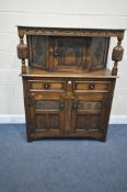 A REPRODUCTION CARVED OAK COURT CUPBOARD, with two drawers and three cupboards, width 110cm x