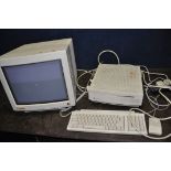 AN APPLE MACINTOSH 2si M0360 VINTAGE PERSONAL COMPUTER with Apple Keyboard 2, an Apple Desktop Bus