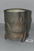 A 19TH CENTURY CHINESE BRONZE BRUSH POT, of bamboo form, cast with shoots and leaves, on three