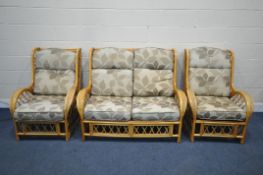 A WICKER FRAMED THREE PIECE CONSERVATORY SUITE, comprising a two seater sofa and two chairs, width