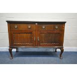 A VICTORIAN MAHOGANY SIDEBOARD, with two drawers, above two cupboard doors, on cabriole legs,