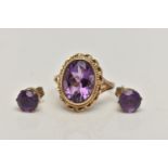 A 9CT GOLD AMETHYST RING AND A PAIR OF AMETHYST EARRINGS, the ring of an oval form set with an