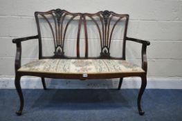 A 19TH CENTURY MAHOGANY TWO SEATER SOFA, with swept open armrests, ribbon detail to back rests,