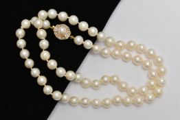 A CULTURED PEARL NECKLACE, each pearl individually knotted on a white string, each pearl measures