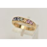 AN 18CT GOLD MULTI GEM RING, set with seven square cut gems in a channel setting, including sapphire