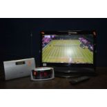 AN E-MOTION X216/69G 21.6ins LCD TV with remote together with a Pure Radio and an Emerson Radio (All