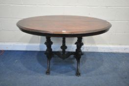 A LATE 19TH/EARLY 20TH CENTURY OVAL CENTRE TABLE, the mahogany top on an ebonised base, with