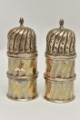 A PAIR OF EDWARDIAN SILVER PEPPERETTES OF DOMED CYLINDRICAL FORM, pull off covers, panelled sides of