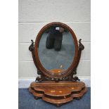 A VICTORIAN FLAME MAHOGANY OVAL BEVELLED EDGE SWING TOILET MIRROR, with foliate details, with a