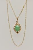 A GEM SET PENDANT AND CHAIN, the oval jade cabochon in a four claw setting with a scrolling