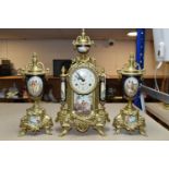 A 20TH CENTURY BRASS AND PORCELAIN CLOCK GARNITURE, the porcelain panels transfer printed with