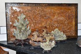 A LARGE ORIENTAL CAMPHOR WOOD WALL HANGING AND FOUR ORIENTAL CARVED STONE ORNAMENTS, comprising a