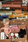 TWO BOXES OF VINTAGE PUZZLES, BOARD GAMES AND PUPPETS, to include a Pelham black French Poodle