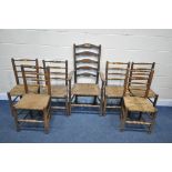 A SET OF SIX 20TH CENTURY OAK RUSH SEATED LADDERBACK CHAIRS, along with a single carver (condition -