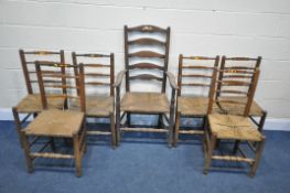 A SET OF SIX 20TH CENTURY OAK RUSH SEATED LADDERBACK CHAIRS, along with a single carver (condition -