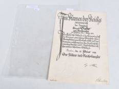 A GERMAN DOCUMENT SIGNED BY ADOLF HITLER, this has an embossed stamp and Hitlers signature at the