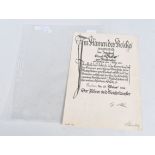 A GERMAN DOCUMENT SIGNED BY ADOLF HITLER, this has an embossed stamp and Hitlers signature at the