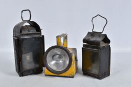 A TWO ASPECT RAILWAY LAMP, with reservoir and burner, clear lens to front with damaged red lens to