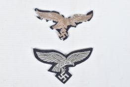 TWO THIRD REICH GERMAN UNIFORM BREAST EAGLES, both have silver thread and feature an eagle with a
