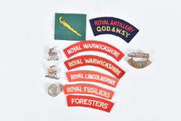 A SELECTION OF WWII ERA AND LATER BRITISH CLOTH SHOULDER TITLES, WWII on loyal service badge and a
