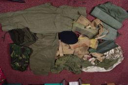 A QUANTITY OF MILITARY RELATED ITEMS, to include four groundsheets, four olive green t shirts,