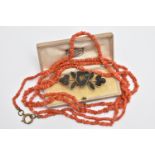 A CARVED BOG OAK BROOCH AND A CORAL BEAD NECKLACE, the brooch in the form of a harp and shamrocks,