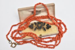 A CARVED BOG OAK BROOCH AND A CORAL BEAD NECKLACE, the brooch in the form of a harp and shamrocks,