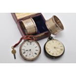 TWO SILVER POCKET WATCHES AND A PAIR OF SILVER NAPKIN RINGS, the first an open face pocket watch key
