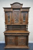 A FRENCH CARVED OAK BUFFET CUPBOARD, with an arrangemt of cupboard doors including a carved and