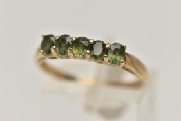 A 9CT GOLD FIVE STONE RING, set with a row of five oval cut green sapphires, each claw set to a