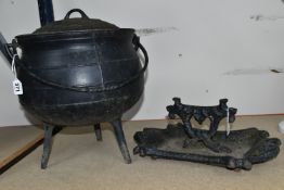 A CAST IRON THREE LEGGED CAULDRON WITH LID AND SWING HANDLE, TOGETHER WITH A WORN VICTORIAN CAST