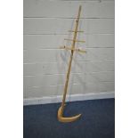 A BESPOKE MAPLE MUSIC STAND, with eight height levels, on a shaped base, height 167cm (condition -