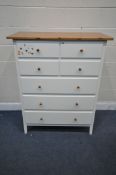 AN IKEA CHEST OF SEVEN DRAWERS, with a white paint effect finish and a pine top and pine handles,