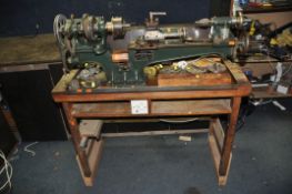 A DRUMMOND BROTHERS VINTAGE METALWORKING LATHE with extra gearing, a three jaw and a four