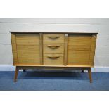 A MID CENTURY ALFRED COX TEAK SIDEBOARD, with two cupboard doors, flanking three drawers, the top
