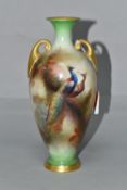 A ROYAL WORCESTER HADLEY SHAPE TWIN HANDLED BALUSTER VASE, hand painted with a peacock and peahen