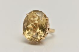A YELLOW METAL CITRINE DRESS RING, large oval cut citrine, measuring approximately length 22.4mm x