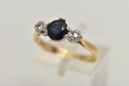 AN 18CT GOLD SAPPHIRE AND DIAMOND RING, a circular cut blue sapphire, set with two illusion set