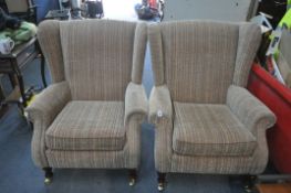 A PAIR OF PARKER KNOLL STRIPPED UPHOLSTERED WING BACK ARMCHAIRS, on brass caps and casters